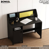 A brown study table with a cork board, white board for notes, and a storage cabinet, branded by BONGO, with a phone, books, and a mug on top.